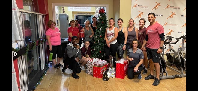 Team members from the Bodies by Design Gym, working with two other businesses in Pflugerville, collected about $7,500 in donations to give to families in need.