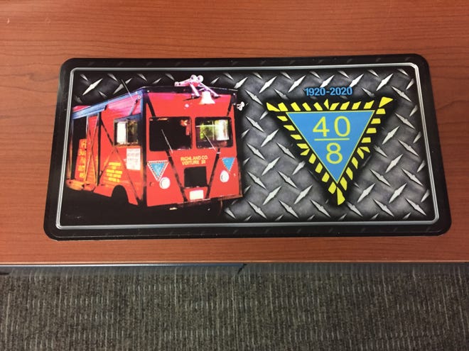 The organization 40 & 8 is selling license plates with a picture of the red boxcar on them.