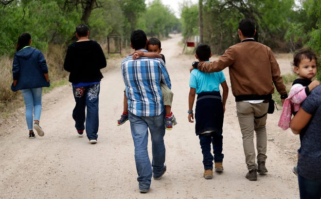 A group of migrant families walk from the Rio Grande, the river separating the U.S. and Mexico in Texas, near McAllen, Texas, March 14, 2019. A Biden administration effort to reunite children and parents who were separated under then-President Donald Trump's zero-tolerance border policy has made increasing progress as it nears the end of its first year. The Department of Homeland Security planned on Dec. 23, 2021, to announce that 100 children, mostly from Central America, are back with their families and about 350 more reunifications are in process after it adopted measures to enhance the program.