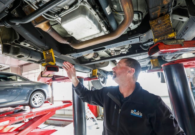 Tim Fess, of Rick's Automotive, points out the catalytic converter in the upper left hand corner of this photo. Experts say a significant increase in the prices of the precious metals housed inside of catalytic converters is driving the spike in thefts.