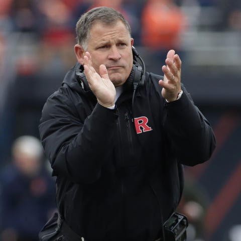 Rutgers head coach Greg Schiano applauds his playe