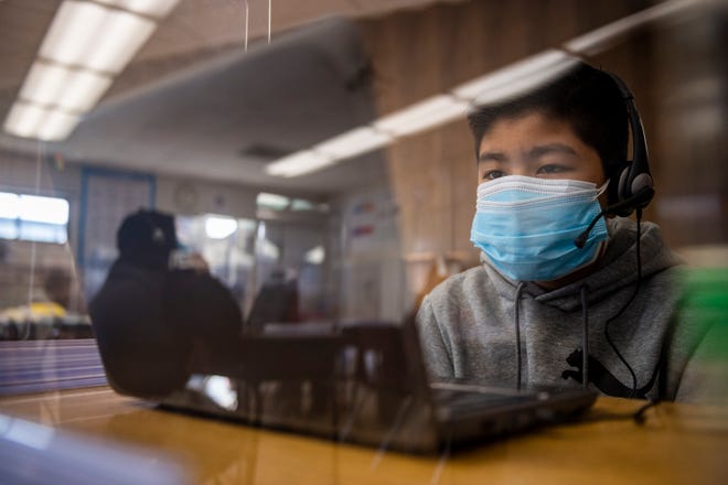 A students wearing a face mask inside his classroom at Virginia Rocca Barton School listens to his teacher during a hybrid in-person and online in Salinas, Calif., on Tuesday, March 23, 2021. 