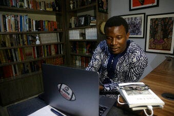 In this photo taken Wednesday Nov 24, 2021, Kola Tubosun, is photograph in his house in Lagos, Nigeria. Computers have become amazingly precise at translating spoken words to text messages and scouring huge troves of information for answers to complex questions. At least, that is, so long as you speak English or another of the world's dominant languages. But try talking to your phone in Yoruba, Igbo or any number of widely spoken African languages and you'll find glitches that can hinder access to information, trade, personal communications, customer service and other benefits of the global tech economy. (AP Photo/Sunday Alamba)