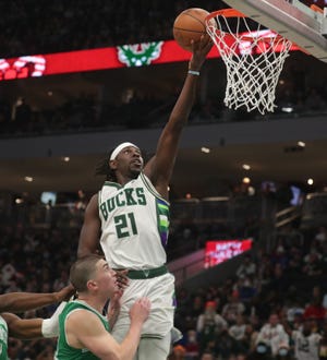 Milwaukee Bucks guard Jrue Holiday (21) lays in a basket during the second half of their 117-113 win over the Boston Celtics at Fiserv Forum in Milwaukee  on Saturday.