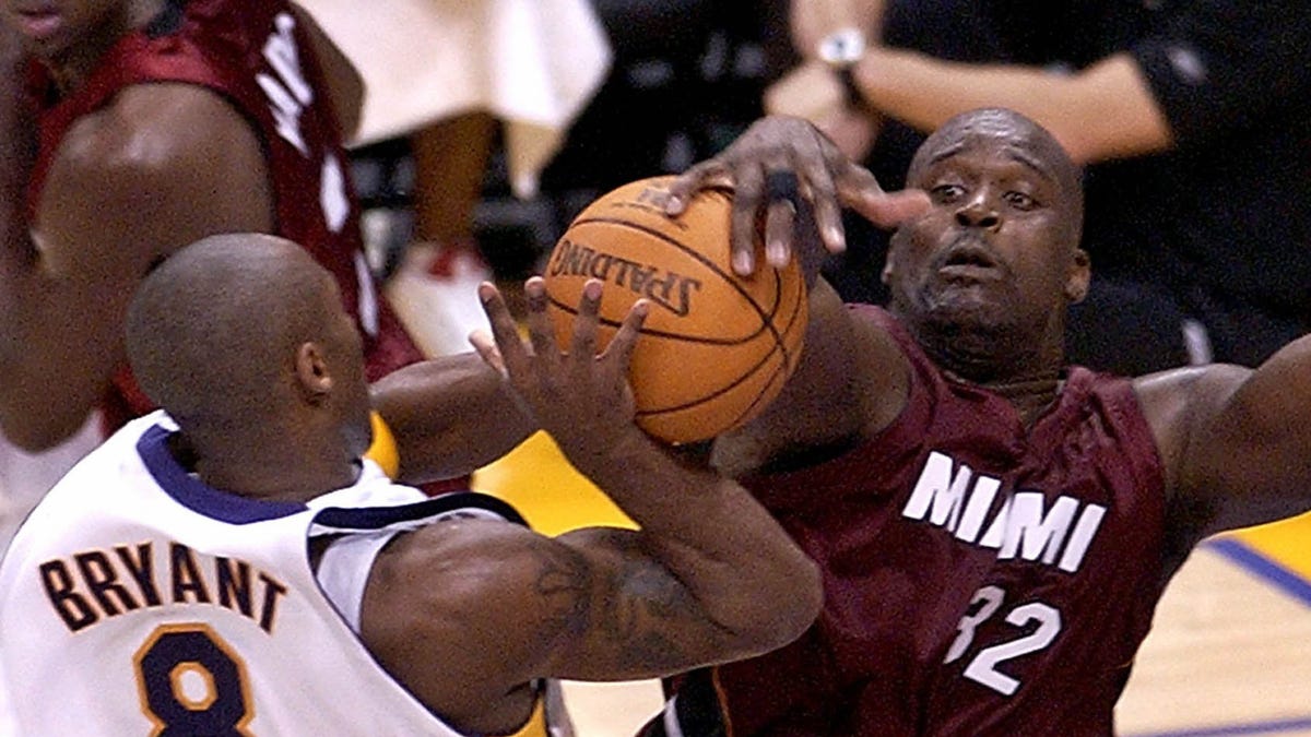 Los Angeles Lakers' Kobe Bryant (8) is fouled by Miami Heat's Shaquille O'Neal during the second half in Los Angeles, Sunday, Dec. 25, 2004. O'Neal fouled out on the play. The Heat won 104-102 in overtime.