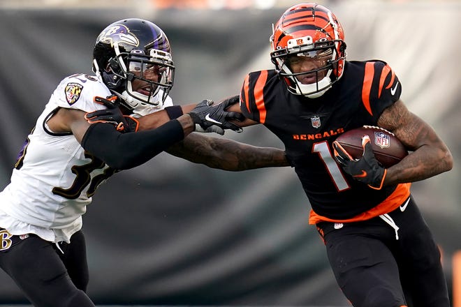 Cincinnati Bengals wide receiver Ja'Marr Chase (1) turns downfield after completing a catch as Baltimore Ravens cornerback Kevon Seymour (38) defends in the third quarter during a Week 16 NFL game, Sunday, Dec. 26, 2021, at Paul Brown Stadium in Cincinnati. The Cincinnati Bengals defeated the Baltimore Ravens, 41-21. 