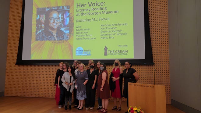 Participants of the “Her Voice” event of the Cream Literary Alliance pose on stage at The Norton Museum of Art on Nov. 12.