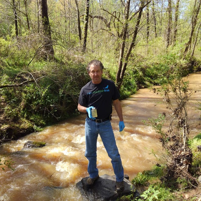 David Caldwell collects water samples.