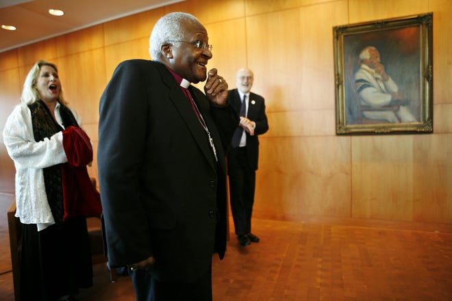 Archbishop Desmond Tutu of South Africa, reacts to the unveiling of his portrait at the Abraham Lincoln Presidential Library on Tuesday, May 13, 2008. Also pictured is the portait's artist Marla Friedman of Wilmette, and Rick Beard, director of the ALPLM. [File/The State Journal-Register]
