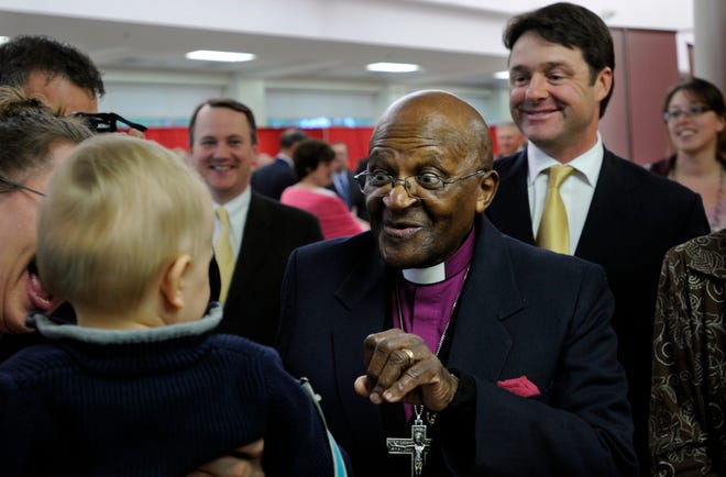 Archbishop Desmond Tutu during a May 2011 visit to St. John's High School in Shrewsbury. At right is Fred Curtis of Princeton, event sponsor, and at left is Lt. Gov. Timothy Murray.