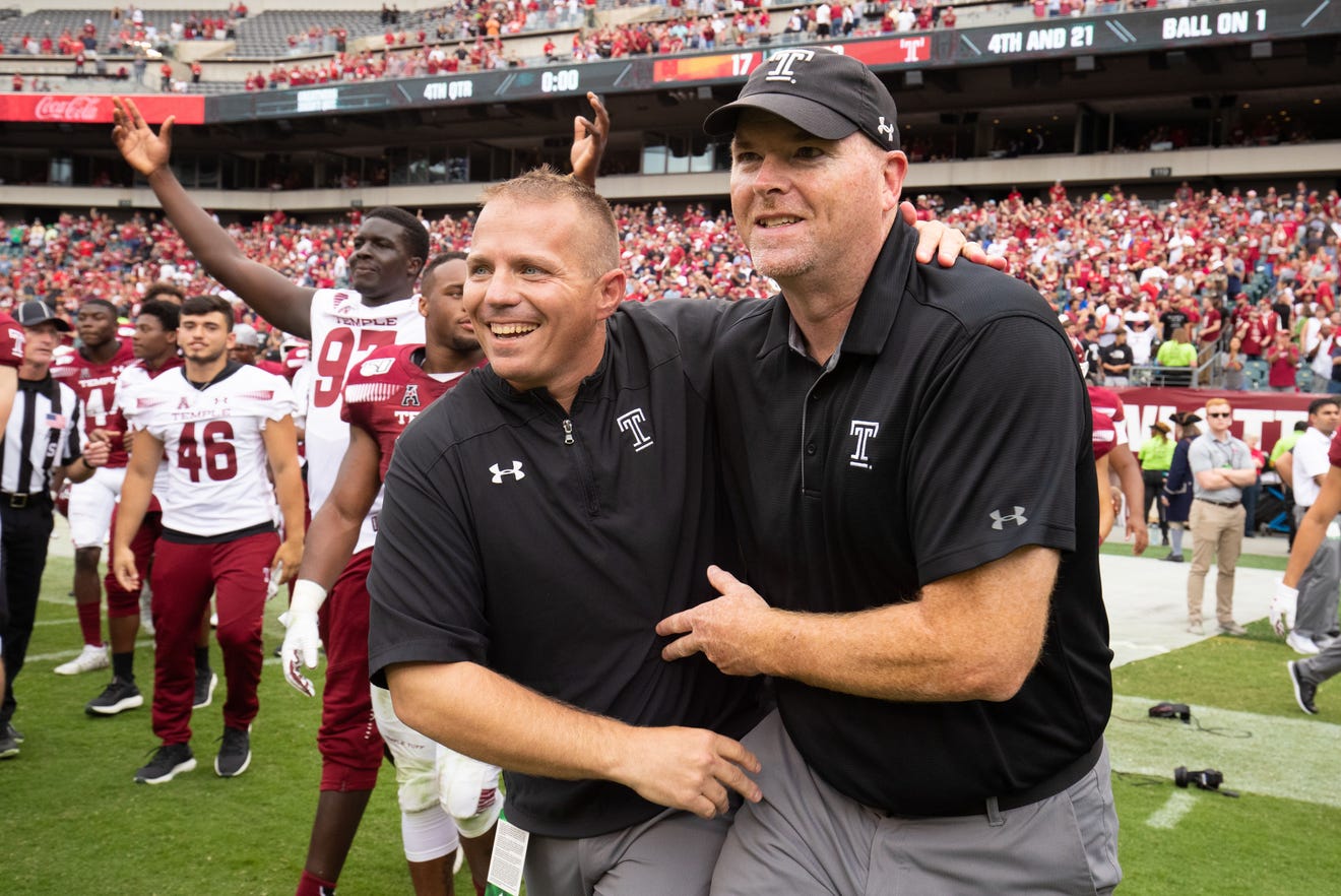 Temple  offensive coordinator Mike Uremovich (left)  and head coach Rod Carey (R) celebrate a win over Maryland. Uremovich was named Butler head coach on Monday.