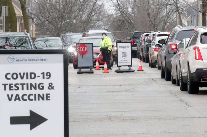 Cars line up at the Southside Health Center free COVID-19 testing site on South 23rd Street in Milwaukee on Dec. 27.