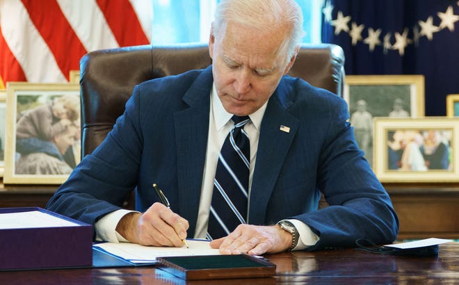 President Joe Biden signs the American Rescue Plan on March 11, 2021, in the Oval Office of the White House in Washington, D.C. (Mandel Ngan/AFP/Getty Images/TNS)
