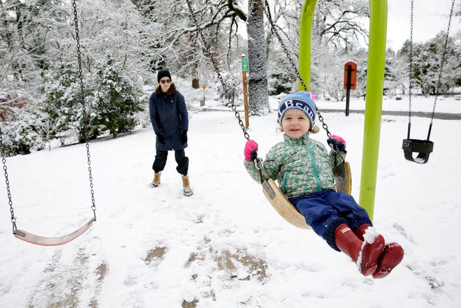 Janie Lewis, 2, is pushed on a swing by her mom Justine Sanfilippo in Bush's Pasture Park in Salem, Oregon, on Monday, Dec. 27, 2021.