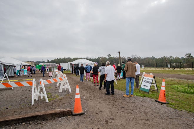 People wait in line to get tested for COVID-19 at the FAMU testing site Monday, Dec. 27, 2021.