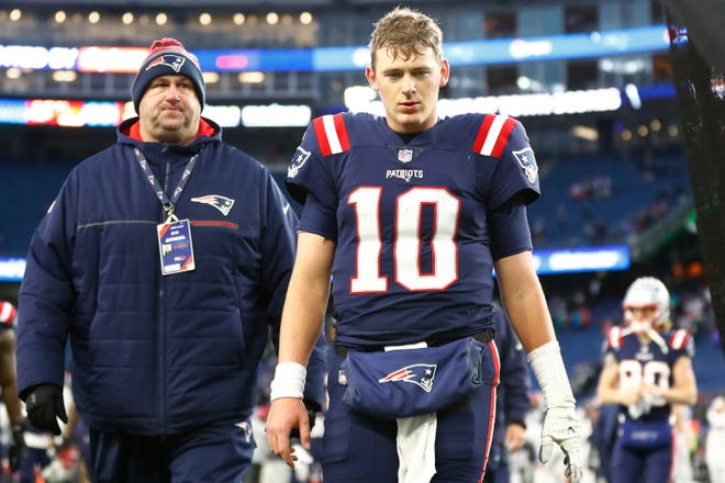 Mac Jones of the New England Patriots walks off the field after being defeated by the Buffalo Bills 33-21 at Gillette Stadium on December 26, 2022 in Foxborough, Massachusetts.
