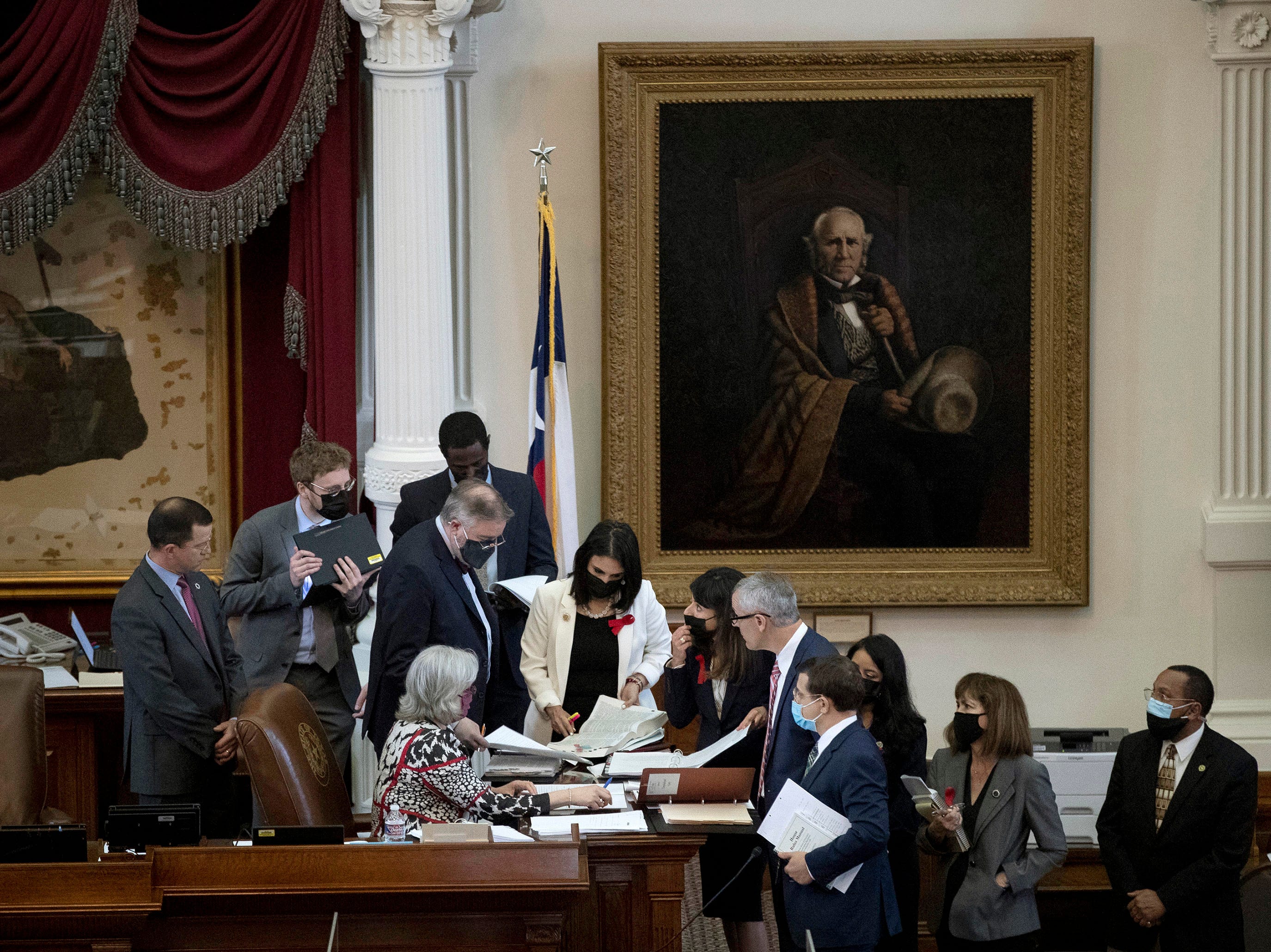 State representatives gather during debate of House Bill 1927 at the Capitol on Thursday April 15, 2021. The bill, later signed by Gov. Greg Abbott, allows holstered handguns to be carried in Texas without a permit.