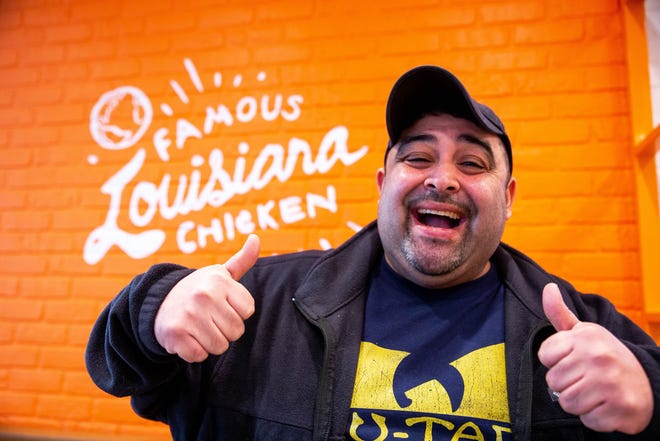 Javier Valdez, also known as Holland's "Popeyes Guy," poses for a photo inside the restaurant ahead of its official opening Tuesday, Dec. 28, at 12340 James St. in Holland. "I couldn't sleep last night," said Valdez when talking about the store's opening, "That's how excited I am."