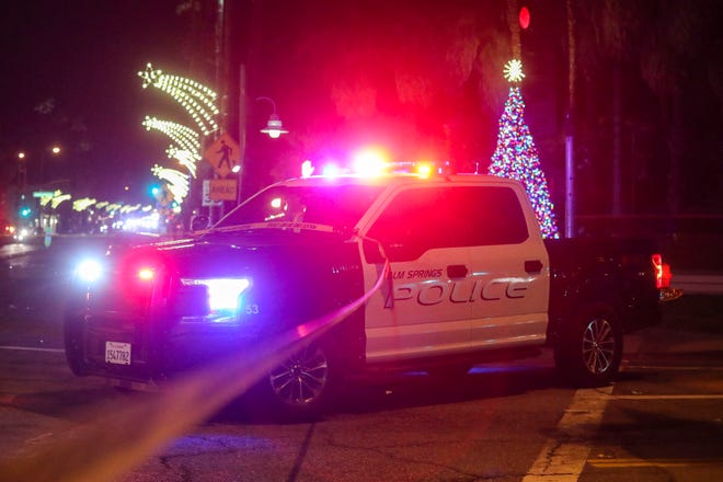 A Palm Springs Police squad vehicle helps block traffic after a fatal crash at the intersection of North Palm Canyon and Alejo Road, Monday, Dec. 27, 2021, in Palm Springs, Calif. 