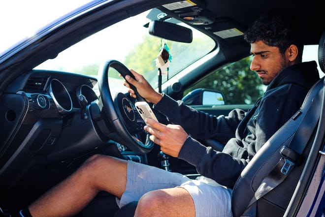 Navjeet Gill, 19, creator of YouTube Channel Navs Garage, poses in his Mustang GT.