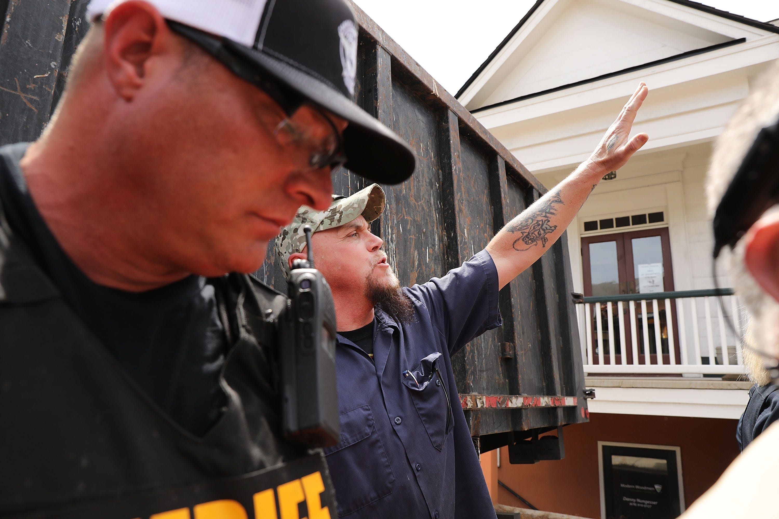 A police officer protects a supporter of the National Socialist Movement, one of the largest neo-Nazi groups in the U.S., before a rally in Georgia in 2018.
