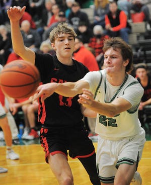 West Branch's Dru DeShields passes as Salem's Drew Weir defends in an Eastern Buckeye Conference game Tuesday, December 28, 2021.