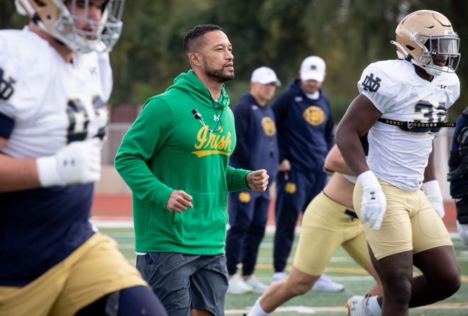 Dec 28, 2021; Scottsdale, AZ, USA; Notre Dame head football coach Marcus Freeman runs with players during practice for the Fiesta Bowl, December 28, 2021, at Chaparral High School, 6935 E. Gold Dust Ave., Scottsdale, Arizona. Mandatory Credit: Mark Henle-USA TODAY Sports