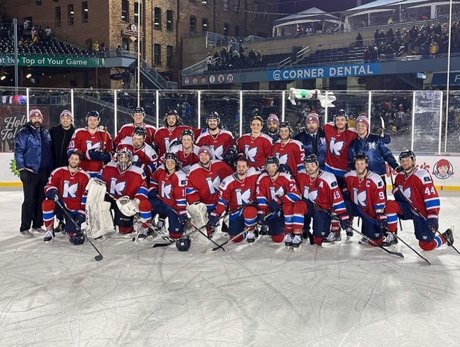 K-Wings players and coaches pose following their 3-2 win in the shootout over the Toledo Walleye during the ECHL Winterfest Game held outside at Fifth Third Field.