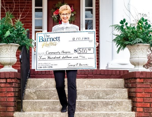 Realtor Norma Ryan is shown stepping out for the annual Barnett Realtors, "We are on the move" 2021 event. Ryan  presented a $500 check to Truman Community Hospice House.