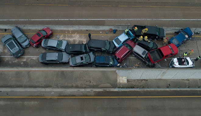 Emergency responders work at a 26-car pileup caused by icy conditions on SH 45 near Briarwick Drive on February 11, 2021. [AMERICAN-STATESMAN/FILE}