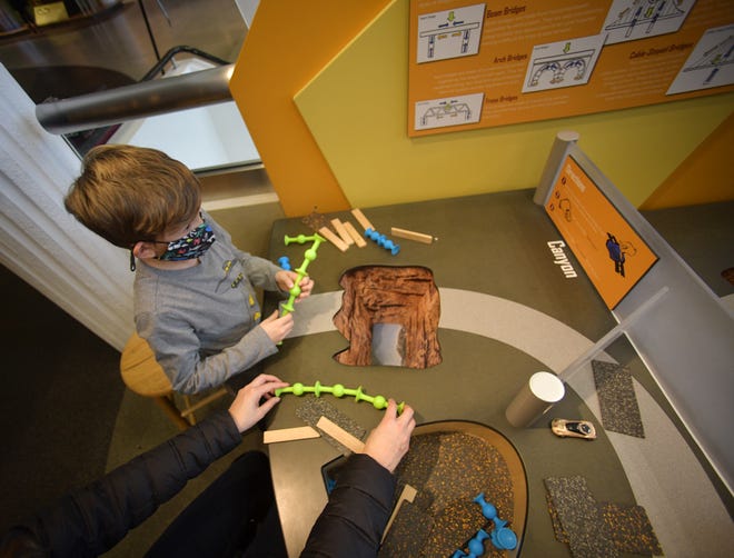 Michael Palin, 9, of Blackstone, visiting the EcoTarium in Worcester Thursday, said he hopes to be an engineer when he grows up. The EcoTarium engineering table was busy with kids building bridges and having fun Thursday.