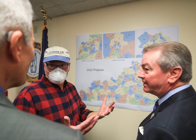Speaker of the House David Osborne, right, talks with Franklin County resident Bill Klier, center, who had questions about redistricting changes after a press conference on Dec. 30, 2021.  At far left is Rep. Jerry Miller-R-Louisville.