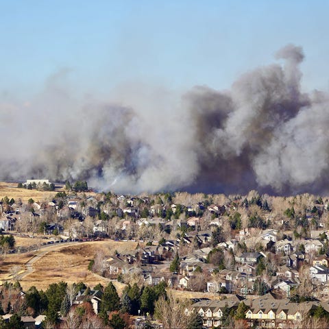 Smoke fills the air over the suburb of Superior, C