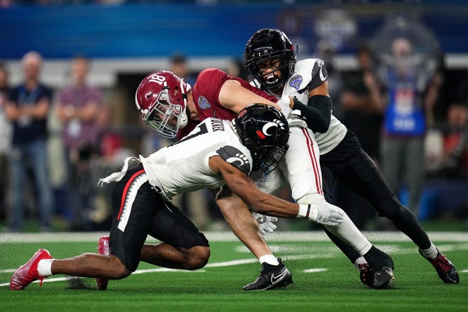 Cincinnati Bearcats wide receiver Tre Tucker (7) and Cincinnati Bearcats wide receiver Tyler Scott (21) tackle Alabama Crimson Tide wide receiver Slade Bolden (18) on a punt in the second quarter during the College Football Playoff semifinal game at the 86th Cotton Bowl Classic, Friday, Dec. 31, 2021, at AT&T Stadium in Arlington, Texas.