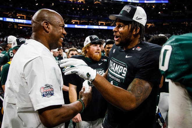 Michigan State coach Mel Tucker and players congratulate each other after the 31-21 win over Pittsburgh in the Peach Bowl at the Mercedes-Benz Stadium in Atlanta on Thursday, Dec.  30, 2021.