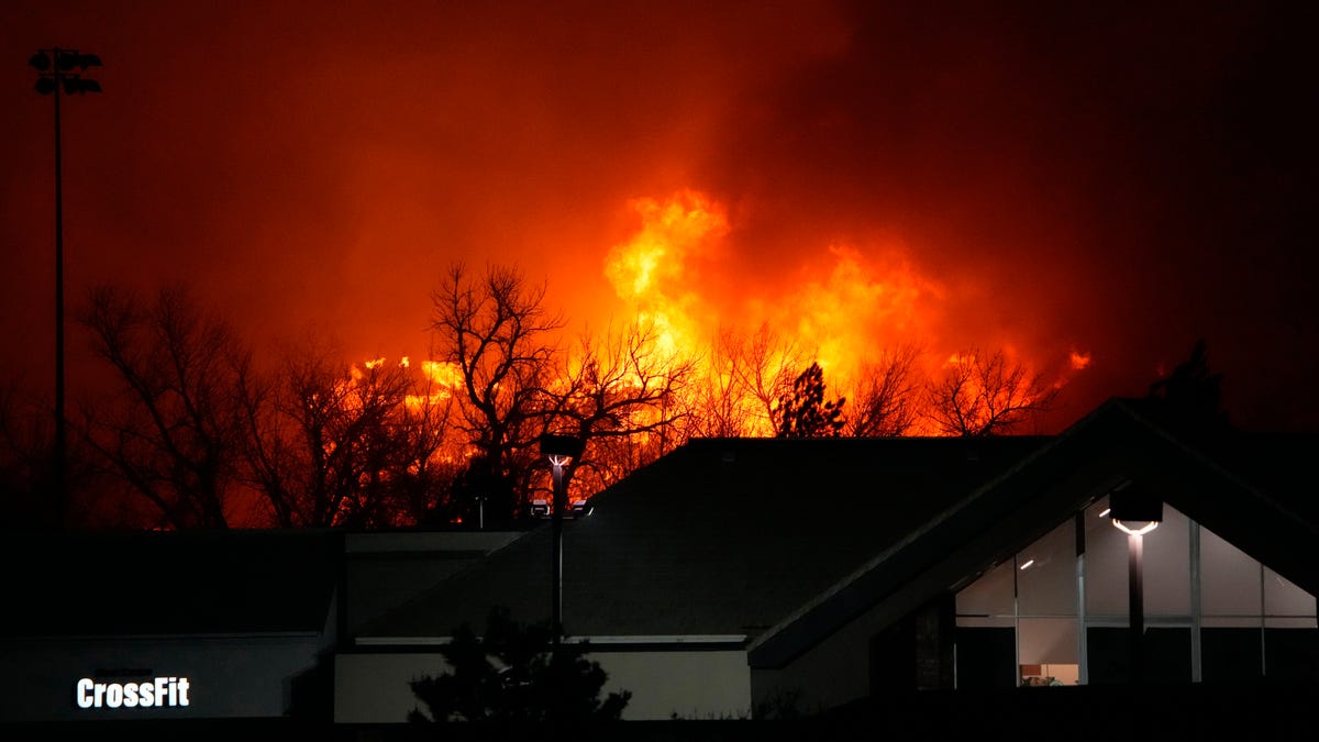 Flames explode as wildfires burned near a small shopping center Thursday, Dec. 30, 2021, near Broomfield, Colo. Homes surrounding the Flatiron Crossing mall were being evacuated as wildfires raced through the grasslands as high winds raked the intermountain West. 