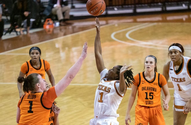 Texas guard Joanne Allen-Taylor shoots over Oklahoma State's Kassidy De Lapp at the Erwin Center in Austin on Feb. 10, 2021. The Longhorns and Cowgirls split their two games last season, with both home team winning.