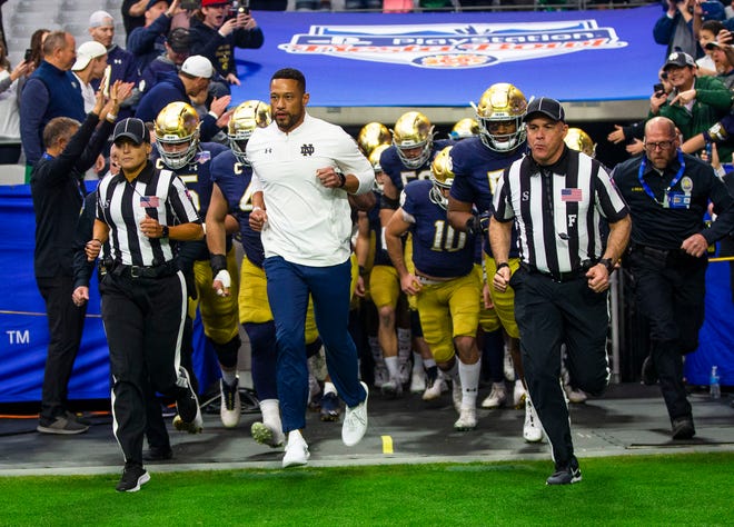 Notre Dame head coach Marcus Freeman leads the team out during the 2022 Playstation Fiesta Bowl Saturday, Jan. 1, 2022 at State Farm Stadium in Glendale, Arizona. 