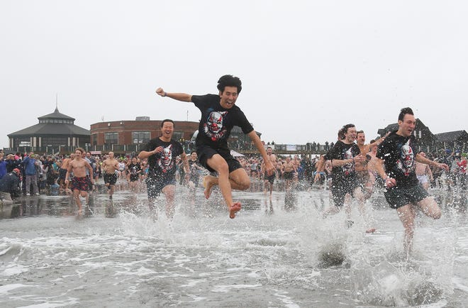 The annual Polar Plunge at Easton's Beach in Newport, Rhode Island, was held on Jan. 1, 2022. The event benefits the Warwick-based nonprofit organization A Wish Come True.