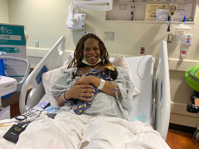 Shamaria Roby holds her newborn baby girl Saturday, Jan. 1, 2022, at her delivery room inside Sparrow Hospital in Lansing. Roby's daughter was the first baby born at Sparrow in the new year.