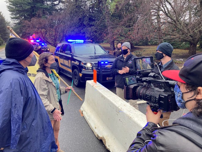 Dozens of people gather at 909 Centre Road in Greenville, on Saturday, Jan. 1, 2022, for the last day of the weeklong Occupy Biden event, where attendees camped out near President Joe Biden's home demanding action on climate change.