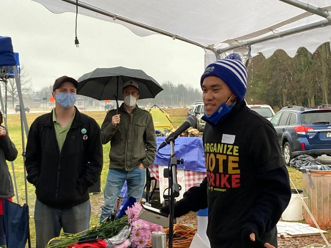 Anthony Chan, a senior at the University of Delaware, speaks to attendees of Occupy Biden, a week-long event held at 909 Centre Road, Wilmington, where attendees camped out near President Joe Biden's home demanding action on climate change. Nearly 50 people later marched to Biden's Wilmington home on Saturday, Jan. 1, 2022.