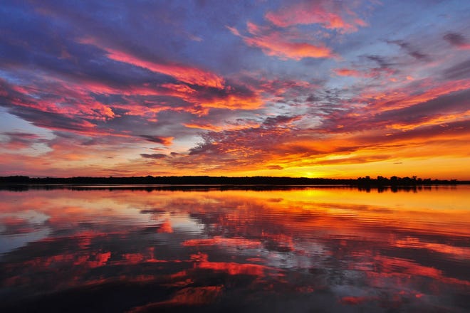 The sun sets over Nimisila Reservoir as seen from the Summit Metro Parks C6 parking lot on Christman Road in Green.