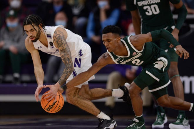 Northwestern's Boo Buie battles Michigan State's Tyson Walker for the ball during the first half Jan. 2, 2022, in Chicago.
