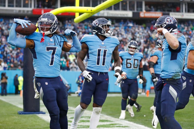 Tennessee Titans running back D'Onta Foreman (7) and quarterback Ryan Tannehill, right, celebrate after Foreman scored a touchdown against the Miami Dolphins in the first half of an NFL football game Sunday, Jan. 2, 2022, in Nashville, Tenn.