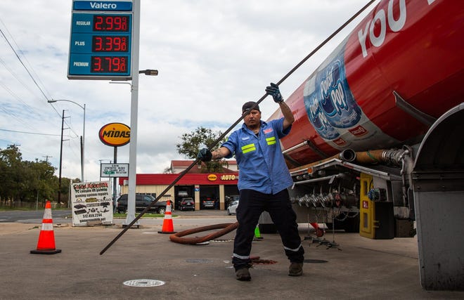 Ruben Rivera looks checks the level of gasoline in the tanks at a Valero station on Guadalupe Street in Austin in this file photo. After a dip in prices, motorists in Austin are again seeing a price hike at the pump.