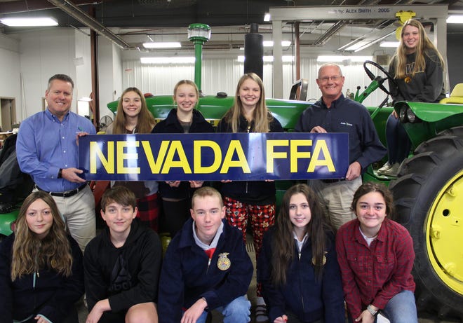 Nevada FFA members receive a donation from AVAILA Bank. Pictured are (front, left to right) Amara Ose, Hunter Barfels, Kaine Albright, Cassidi Bartmess, August Martinez, (back row) Randy Clary of AVAILA, Faith Meyer, Leah Biensen, Kennedy Long, Brad Murty of AVAILA and Ellla Toot on the tractor seat. Not pictured is Kevin Cooper, Nevada High School agriculture education instructor and FFA advisor.