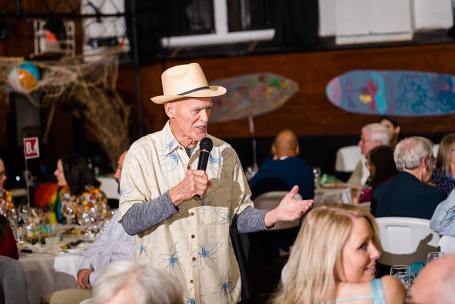 Clinton auctioneer William "Bear" Stephenson encourages bids from guests during the live auction at the Children’s Museum Gala.
