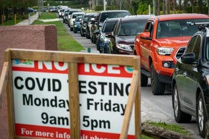 People line up for COVID-19 testing at a county-run drive thru site at Caloosa Park in Boynton Beach, Florida on January 3, 2021