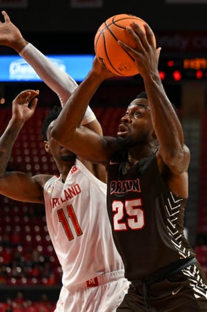 Brown forward Tamenang Choh goes up for a shot against a Maryland player in a game last week. Choh led the Bears with a career-high  26 points against Penn on Sunday.